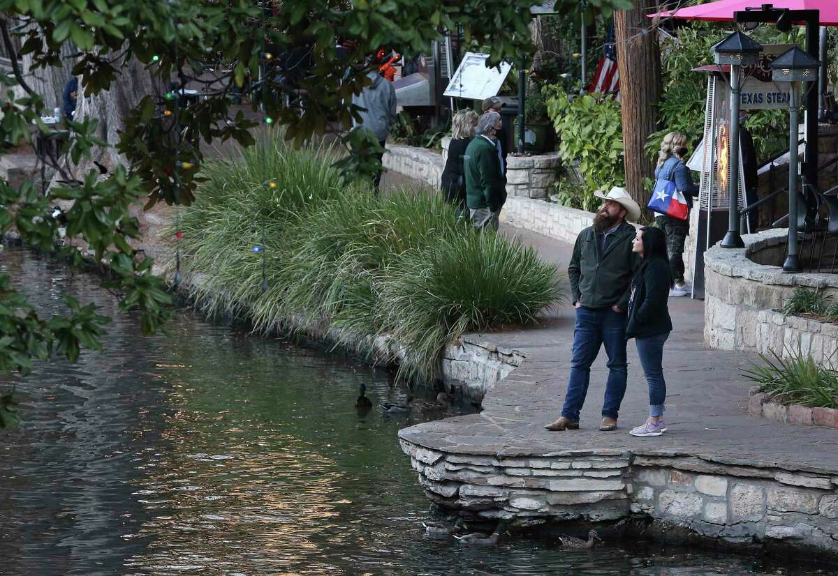 Some visitors to downtown San Antonio and the River Walk are seen not wearing masks on Friday, Jan. 8, 2021.