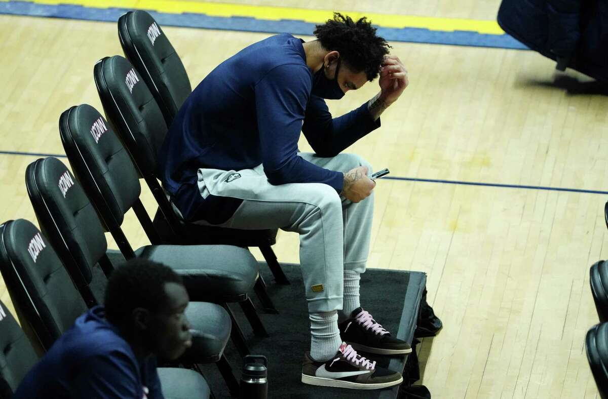 UConn guard James Bouknight sits on the sideline as his teammates warm up before a game against Butler in Storrs on Jan. 26.