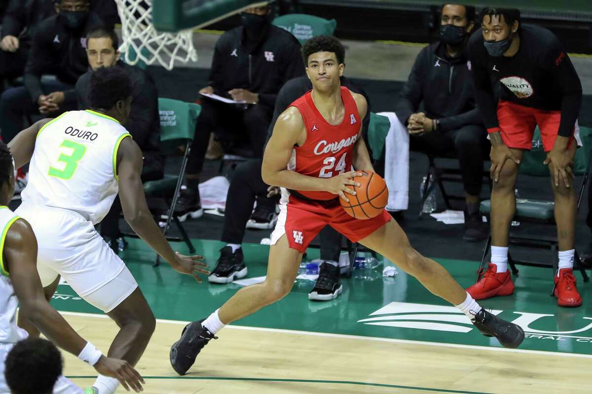 Houston's Quentin Grimes steps out to shoot against South Florida's Prince Oduro during the second half of an NCAA college basketball game Wednesday, Feb. 10, 2021, in Tampa, Fla. Houston won 82-65. (AP Photo/Mike Carlson)