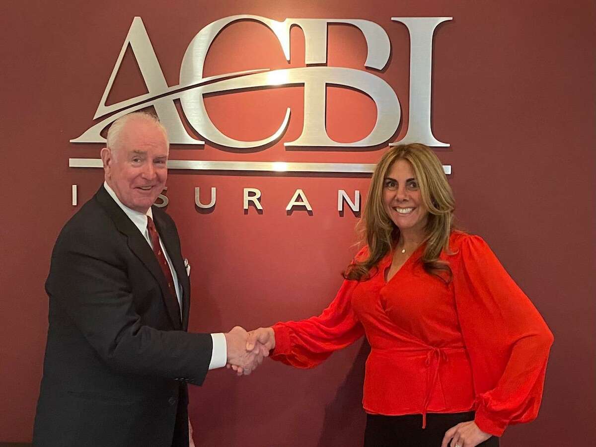 Daniel F. Keane, president of ACBI Insurance in Shelton, left, welcomes Kim DiMatteo, right, as the new senior vice president at ACBI Insurance. DiMatteo Insurance in Shelton merged in early 2021 with ACBI Insurance to become one of the largest insurance firms in Connecticut with their combined 3,000 clients and 40 employees.
