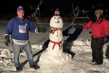 Joshua Nessen and Selina Cohen with Frosty February Nessen the Fourth, at their home in Weston on Feb. 4.