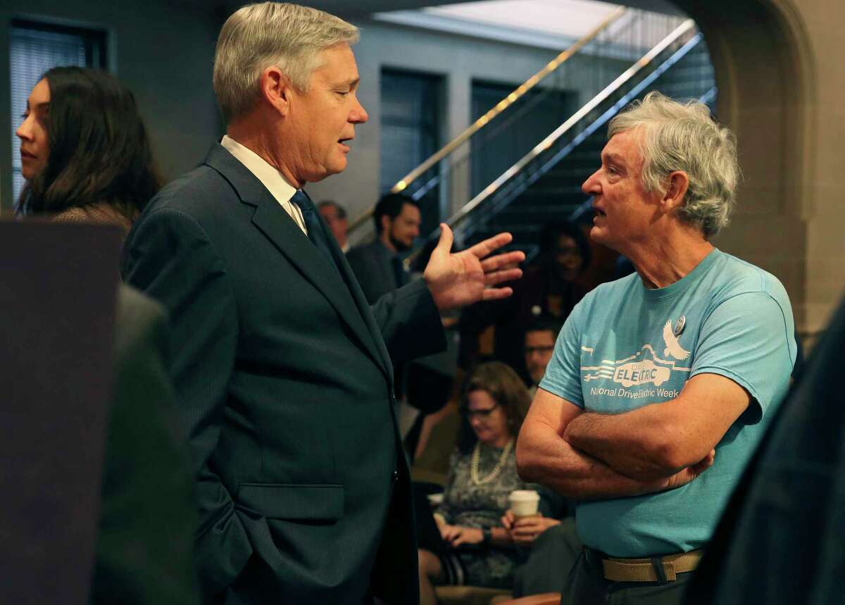 District 10 Councilman Clayton Perry, left, talks with Alan Montemayor, right, a supporter of the Climate Action and Adaption Plan, in pre-coronavirus days, before the start of the council’s regular meeting, Oct. 17, 2019. The council voted 10-1 that day to pass the plan with Perry the lone vote against it. Thursday, the council is set to vote on hiring a firm to promote the plan.
