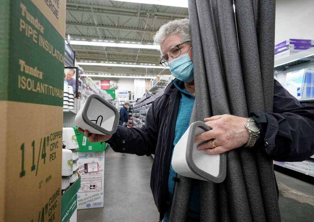John Armour shops for faucet covers and pipe insulation at M&D Supply Ace Hardware, Wednesday, Feb. 10, 2021, in Cypress, Texas. Potential freezing temperatures are being forecast for this weekend into midweek for Southeast Texas. (Melissa Phillip/Houston Chronicle via AP)