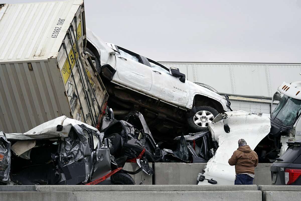 Vehicles are piled up after a fatal crash on Interstate 35 near Fort Worth, Texas on Thursday, Feb. 11, 2021. The massive crash involving 75 to 100 vehicles on an icy Texas interstate killed some and injured others, police said, as a winter storm dropped freezing rain, sleet and snow on parts of the U.S. (Lawrence Jenkins/The Dallas Morning News via AP)