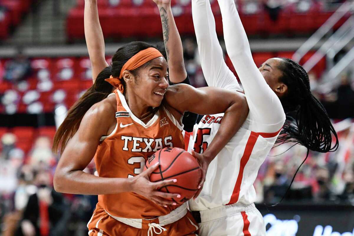Texas junior center Charli Collier, left, scored her 1,000th career point on a fourth-quarter layup vs. Oklahoma State.