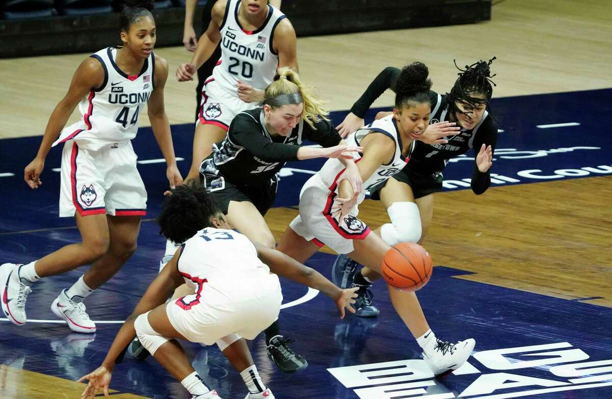 Connecticut guard Evina Westbrook, second from left, works for the ball against the Georgetown in the second half of an NCAA college basketball game Saturday, Jan. 23, 2021, in Storrs, Conn. (David Butler II/Pool Photo via AP)