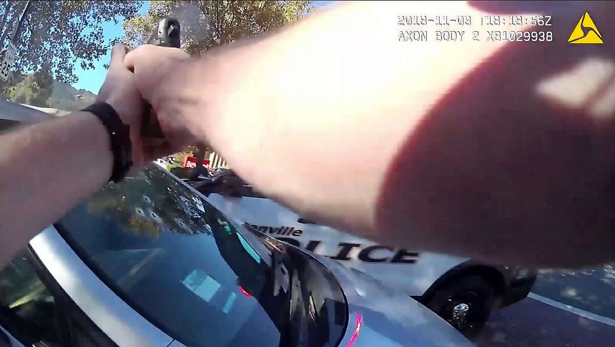 A still frame taken from body-worn camera footage shows Danville police officer Andrew Hall firing his weapon at a vehicle driven by Laudemer Arboleda on November 3, 2018 in Danville, Calif.