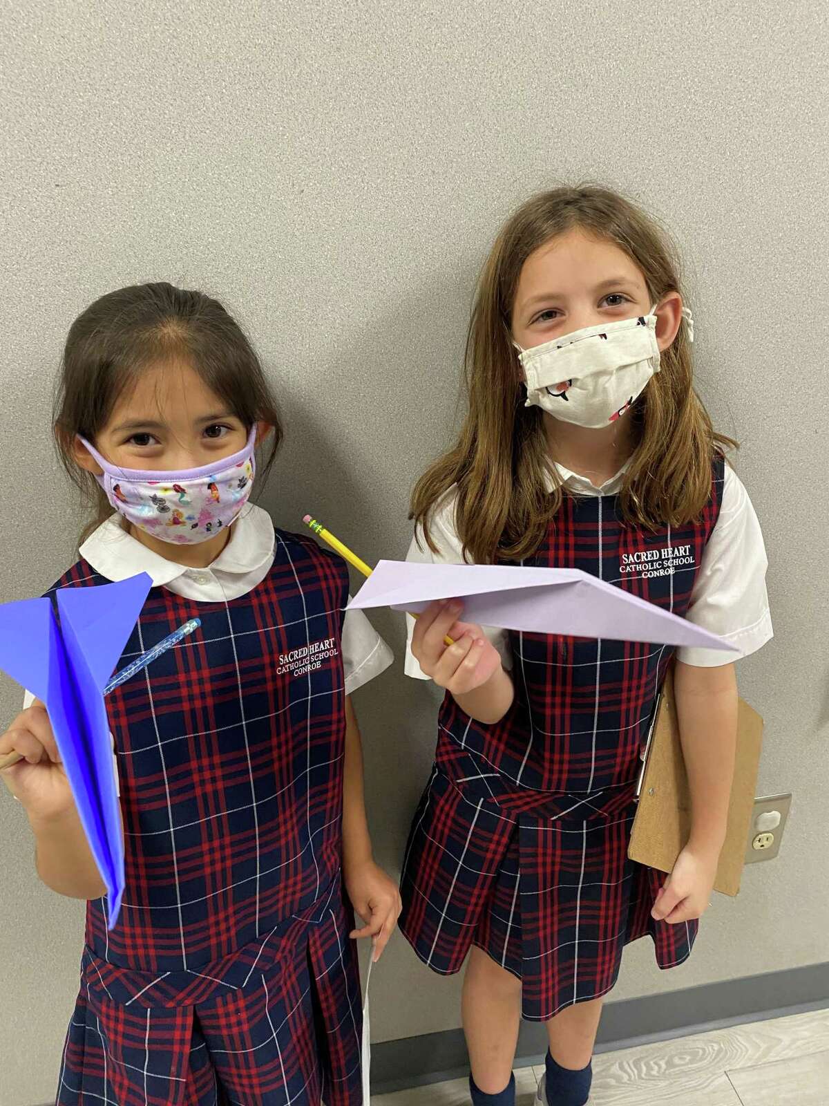 Second graders Ally Gonzales and Anna Beth Lee discover how to apply the scientific method during a S.T.R.E.A.M. (Science, Technology, Religion, Engineering, Art, and Math) activity with airplanes during Catholic Schools Week at Sacred Heart Catholic School.