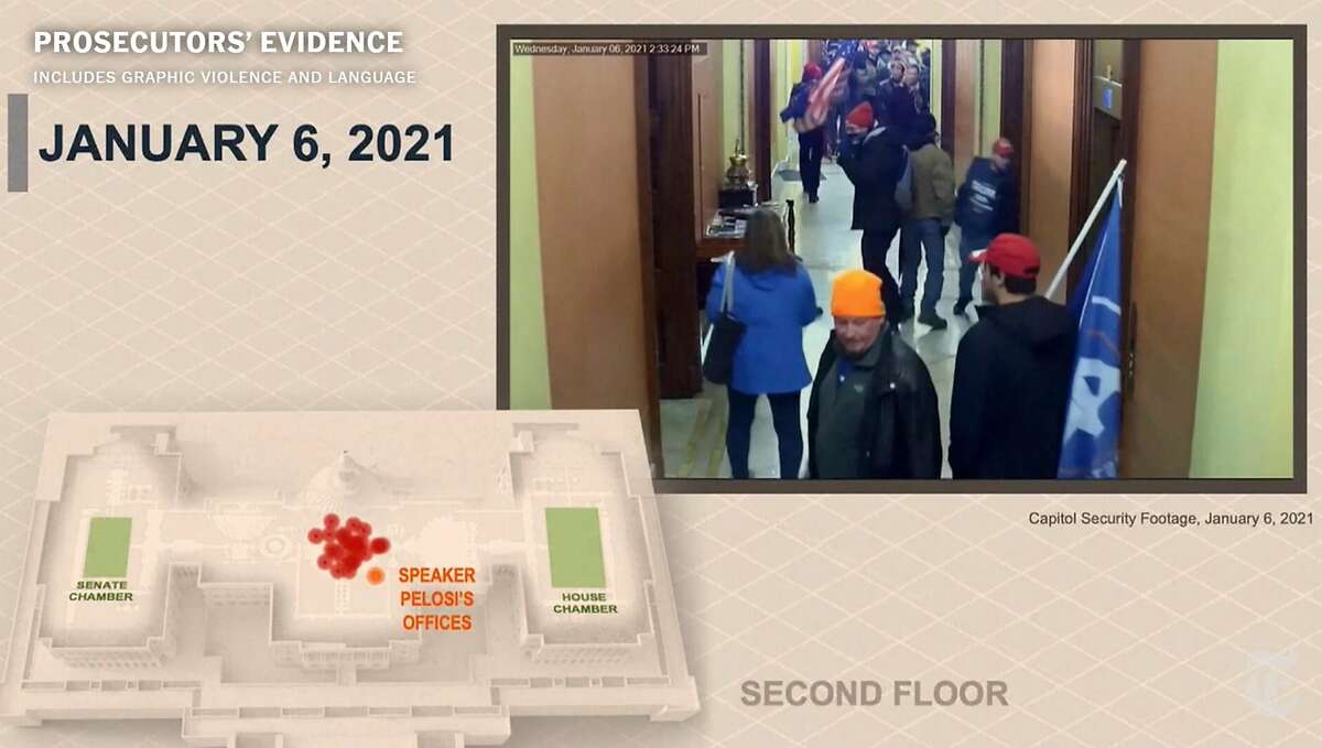 An image provided by a U.S. Capitol security camera shows a rioter, right, trying to break a door where workers from the offices of House Speaker Nancy Pelosi had fled during the Jan. 6 riot.