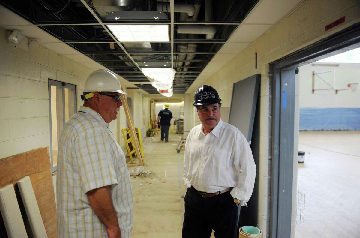 Danbury Superintendent of Construction Services Tom Hughes, left, and Danbury Superintendent of Schools Dr. Sal Pascarella look at the construction progress of the new Westside Middle School Academy in Danbury on June 24, 2014.