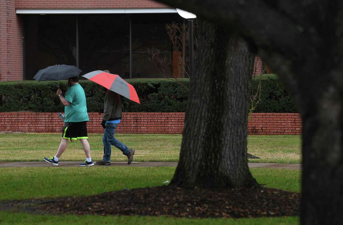 Students at Lamar University had rainy campus treks Thursday afternoon as showers and dropping temperatures moved into the region. Photo taken Thursday, February 11, 2021 Kim Brent/The Enterprise