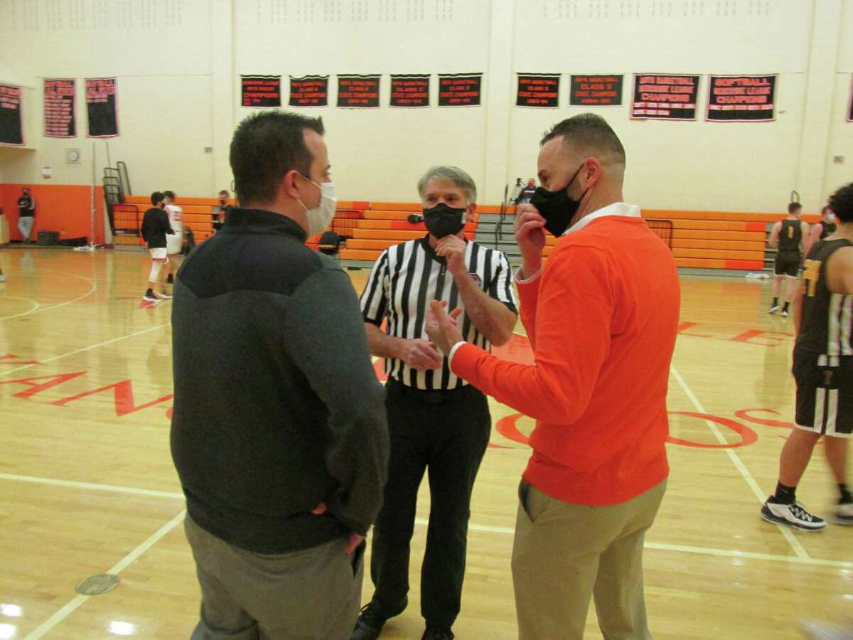 Thomaston coach A.J. Bunel, left, and Terryville coach Mark Fowler, rivalry veterans from their own playing days, talk COVID protocols with referee Terry Musselman before Terryville’s win on Friday.
