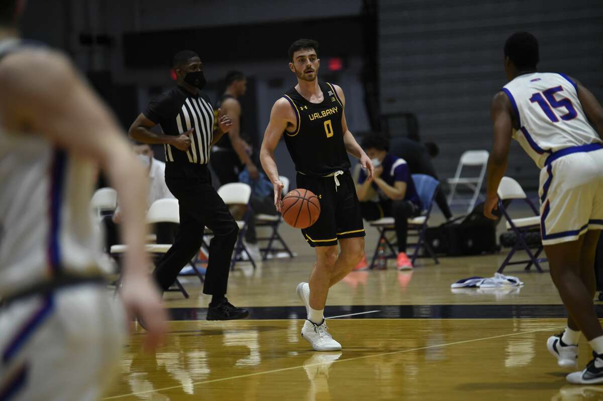 UAlbany's Antonio Rizzuto surveys the UMass Lowell defense on Saturday, Feb. 13, 2021.