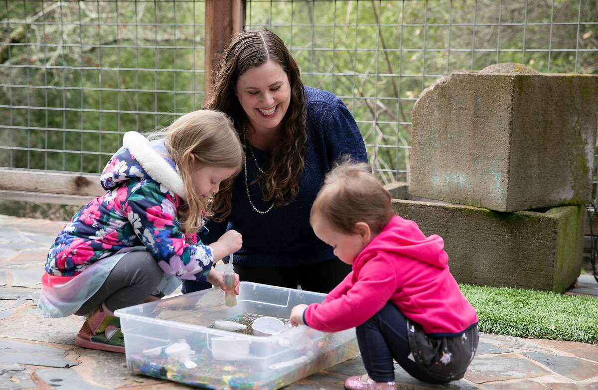 Gennie Gorback, president-elect of the California Kindergarten Assocation, plays with her daughters Tilly and Cece at their home in Orinda. Tilly has been doing online preschool this year.