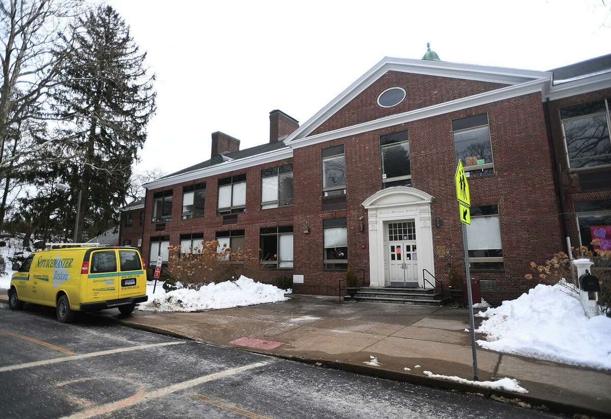 A cleanup crew is on site at North Mianus Elementary School following this weekend's flooding caused by a frozen and burst second floor pipe in Greenwich, Conn. on Sunday, February 14, 2021.