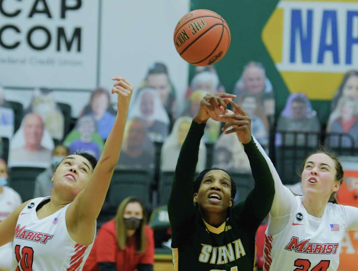 Siena's Tobulayefa Watts, center, battles for a rebound against Caitlin Weimar, left, and Sarah Barcello of Marist during their game on Sunday, Feb. 14, 2021, in Loudonville, N.Y. (Paul Buckowski/Times Union)