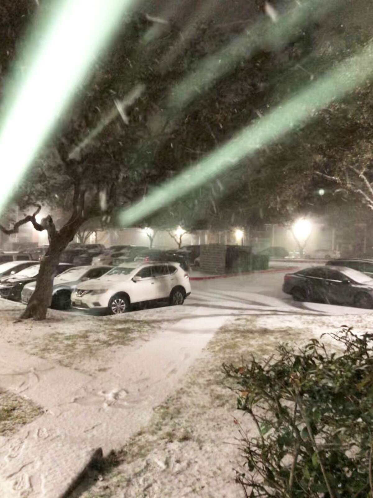 Snow falls at a North Side San Antonio apartment complex Sunday night, Feb. 14, 2021.