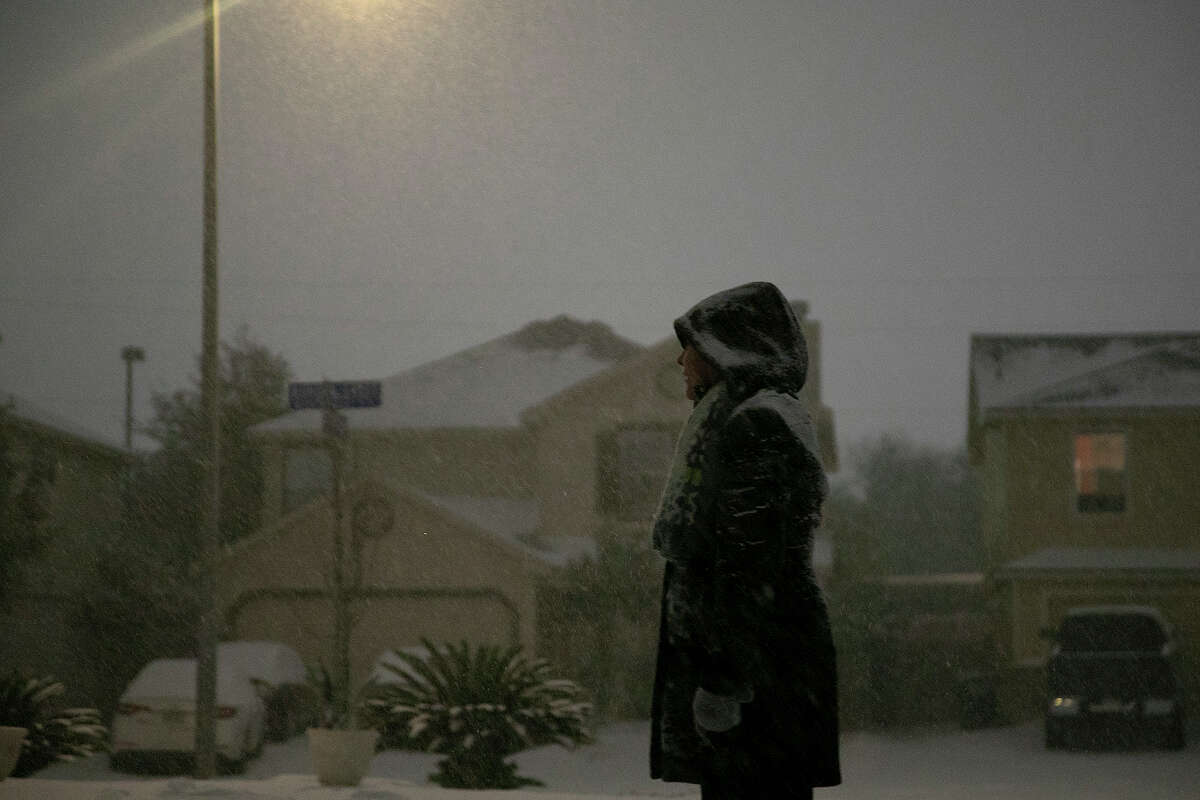 Georgina Rodriguez watches the snow fall late Sunday night, Feb. 14, 2021, in San Antonio.