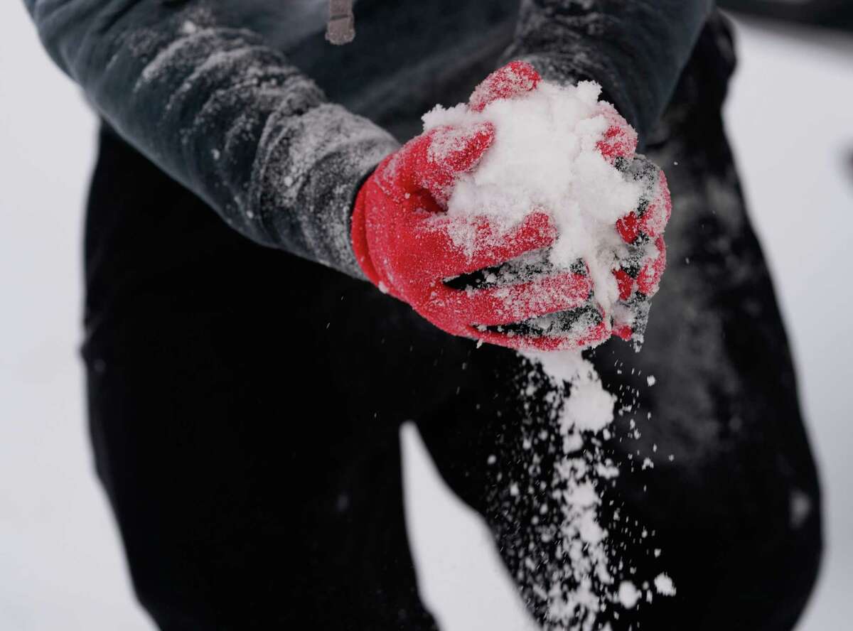 Roberto Sanchez, 18, plays in the snow with his brother, Santi Sanchez, 3, during the arctic storm Monday, February 15, 2021 in Houston.