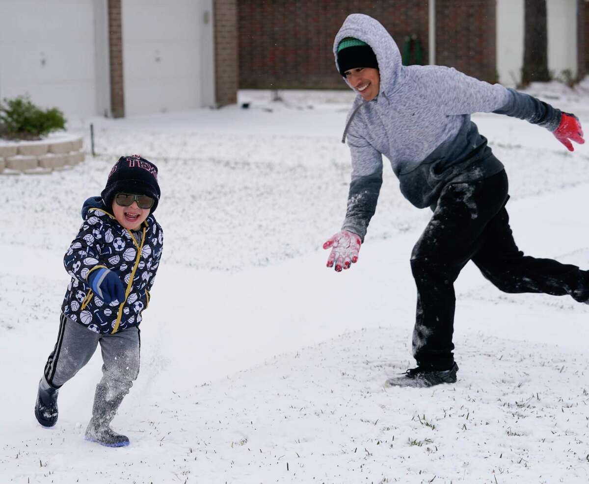 Roberto Sanchez, 18, plays in the snow with his brother, Santi Sanchez, 3, during the arctic storm Monday, February 15, 2021 in Houston.