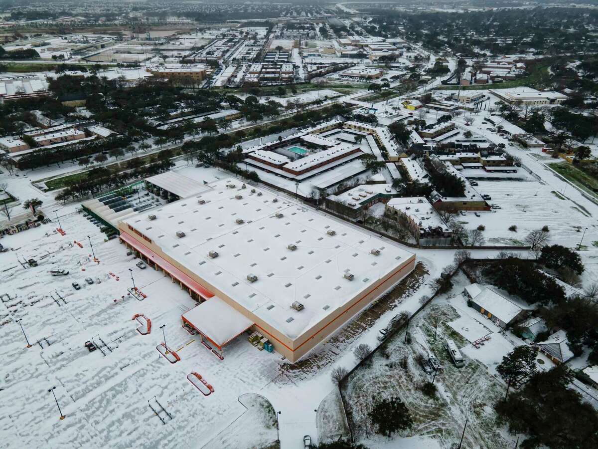 A Home Depot parking lot is blanketed in snow in the Westbury neighborhood on Monday, February 15, 2021, in Houston.