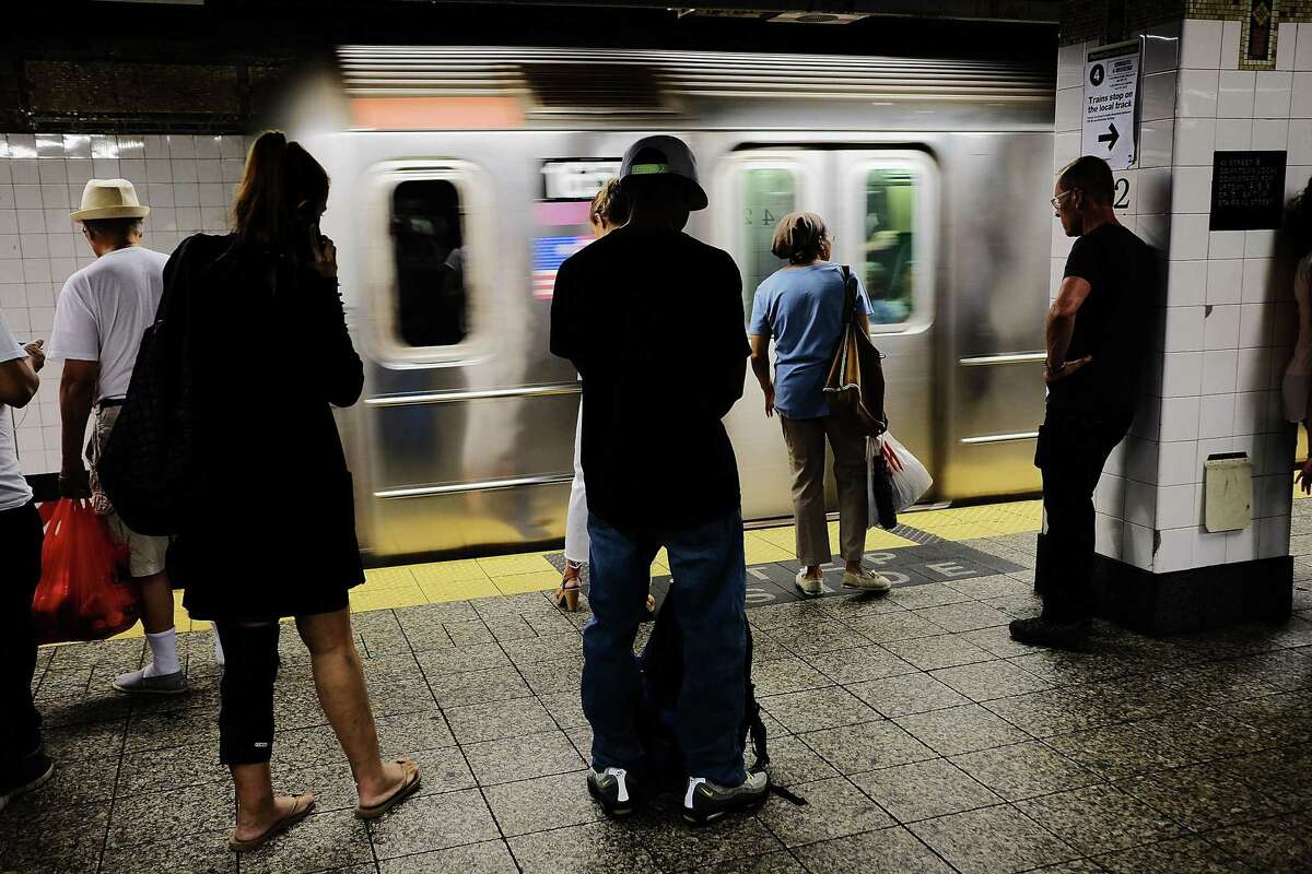 People wait for a Metropolitan Transportation Authority (MTA) subway to arrive in New York City.