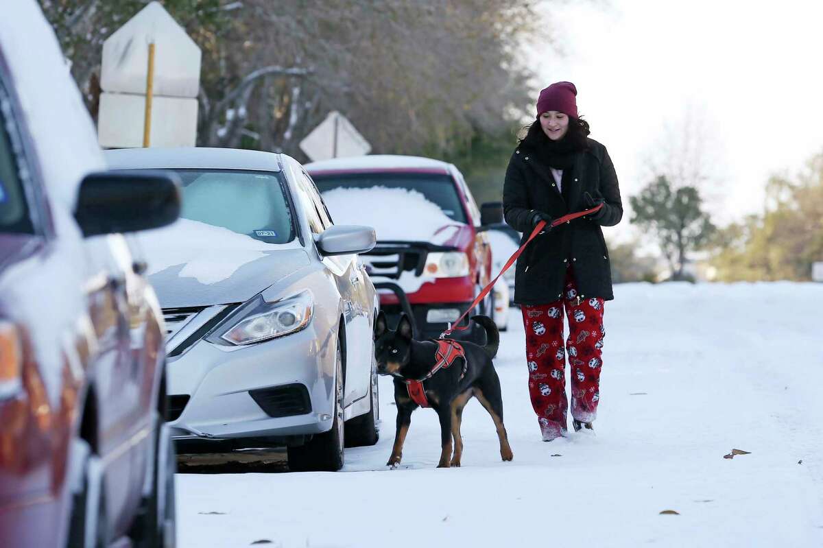 Amy Maltos, 18, walks her dog, Sora, in the Villages of Westcreek subdivision of far Northwest San Antonio, Monday, Feb. 15, 2021. About 3 to 5 inches of snow fell in San Antonio, and more piled up in the Hill Country.