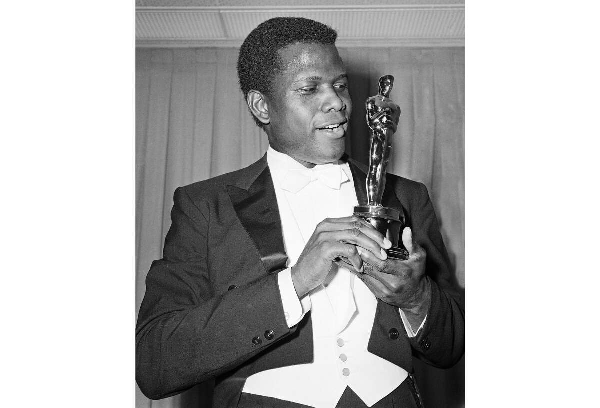 Actor Sidney Poitier appears with his Oscar for best actor, for his role in "Lillies of the Field," at the 36th Annual Academy Awards in Santa Monica, Calif., on April 13, 1964.