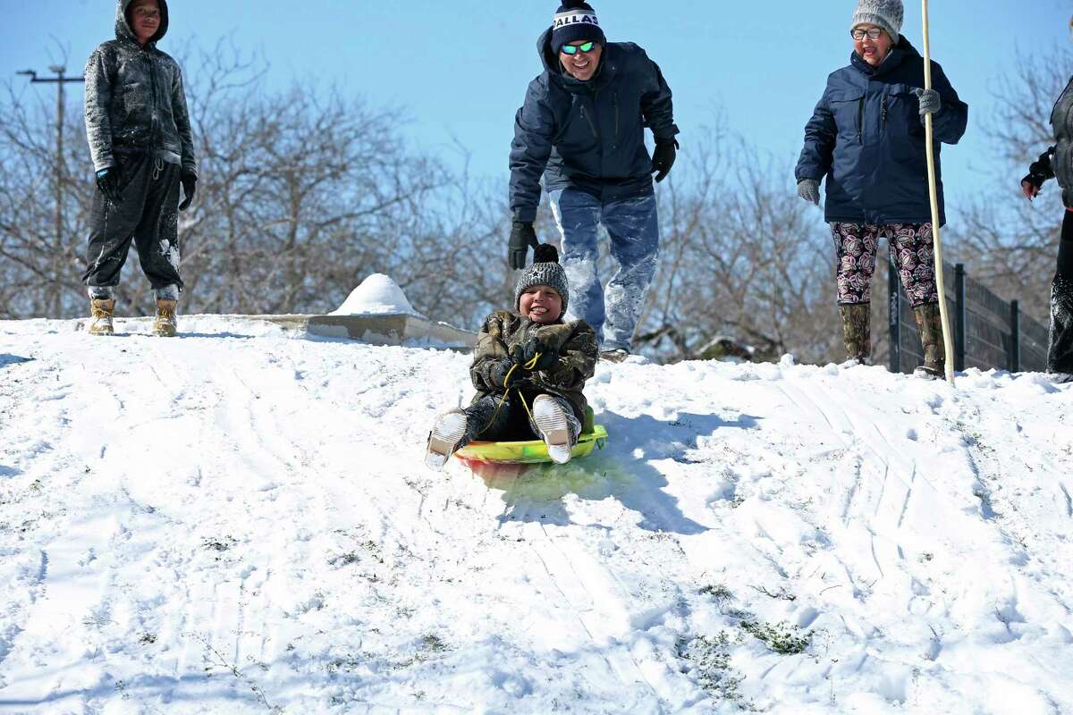 Josie Lopez, 13, rides a snowboard down a hill at the Heritage Duck Pond Park, Monday, Feb. 15, 2021.