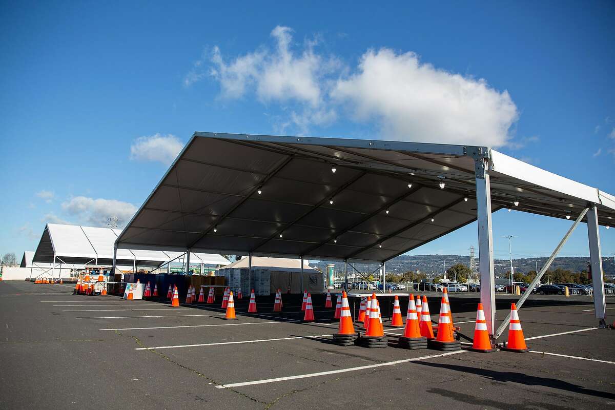 Large tents are set up for the drive-through portion of the mass vaccination site at the Oakland Coliseum on Friday.