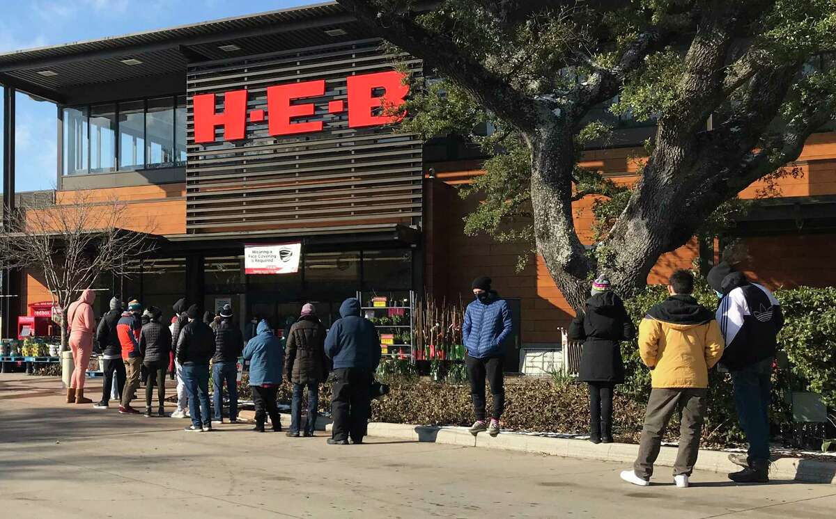 Shoppers line up outside HEB grocery store in Houston on Monday, February 15, 2021. The store cut back its hours because of the weather.