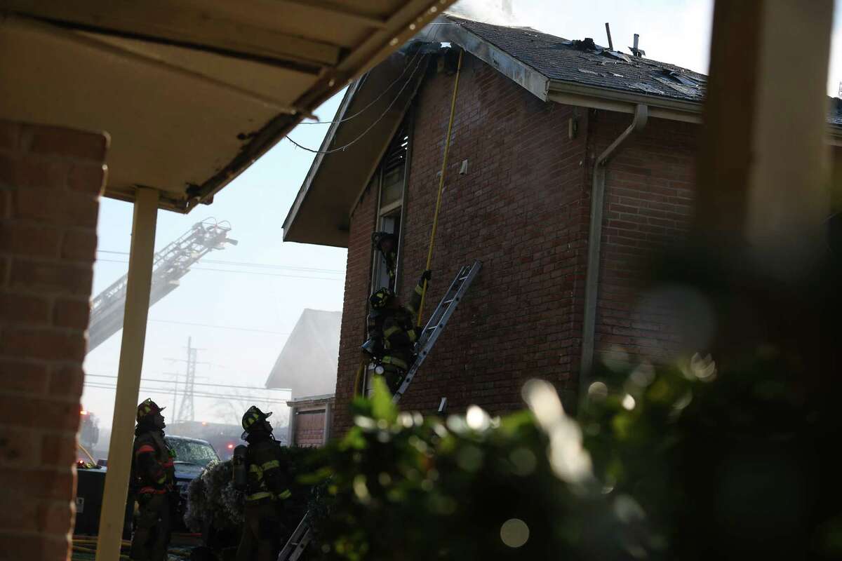 Houston firefighters respond to a fire that damaged at least three buildings at an apartment complex on the 6000 block of Bellaire Boulevard Monday, Feb. 15, 2021, in Houston. About 80 people were displaced, an HFD official said.