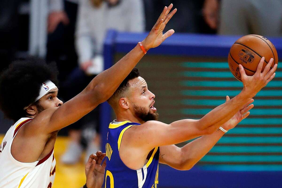 Golden State Warriors' Stephen Curry scores past Cleveland Cavaliers' Jarrett Allen in 1st quarter during NBA game at Chase Center in San Francisco, Calif., on Monday, February 15, 2021.