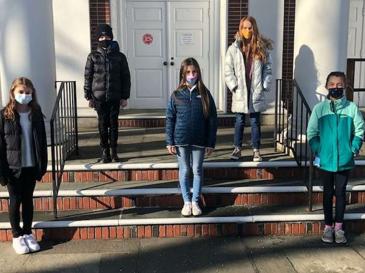 DAR fifth grade essay contest winners gathered socially distanced on the front steps of the Noroton Presbyterian Church. Second place winner Madeline Wren; front, left, first place winner Georgina Cappella; with third place winner, Noa Durocher-Pyun. At back are honorable mention winners Momo Schoenemann and Cara McElrea. The DAR usually hosts a reception at the Noroton Presbyterian Church Parlor for student winners, their parents, and teachers, but due to the pandemic this year’s event was not held.