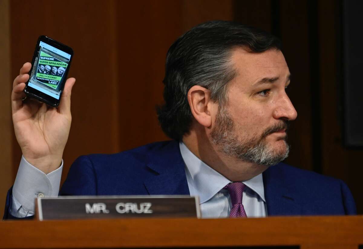 U.S. Sen. Ted Cruz (R-TX) holds up a phone as Supreme Court nominee Judge Amy Coney Barrett testifies before the Senate Judiciary Committee on the third day of her Supreme Court confirmation hearing on Capitol Hill on October 14, 2020 in Washington, DC.