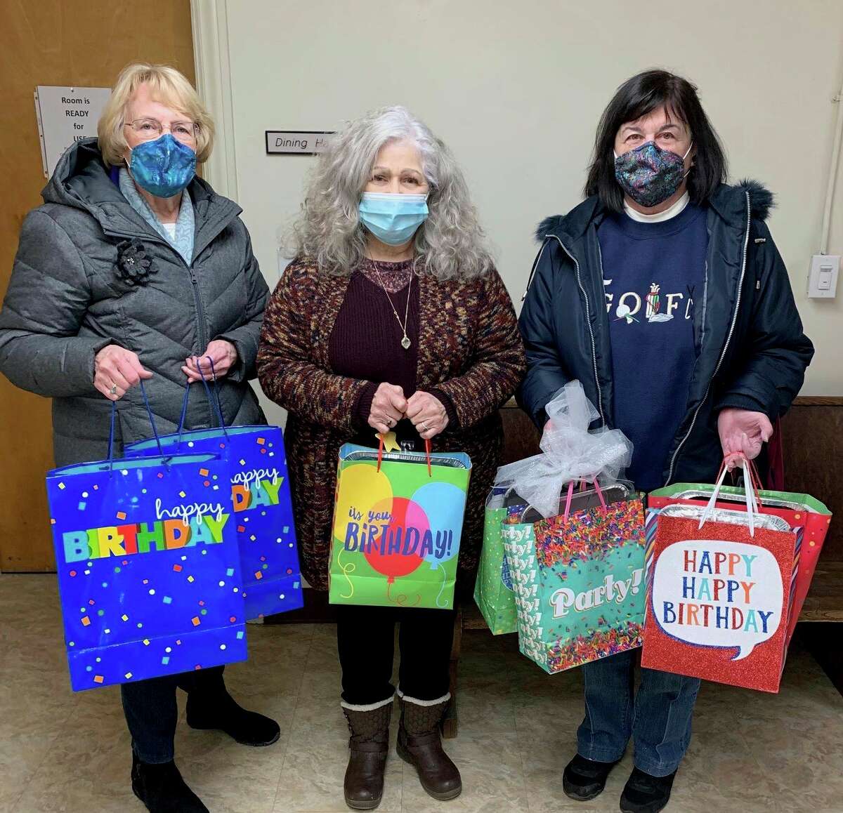 Spreading birthday cheer with bags full of goodies includes, from left, GFWC Member Melanie Henry, Diane Long, Project Starburst Executive Director and GFWC Member Pat Rossi. (Courtesy photo)