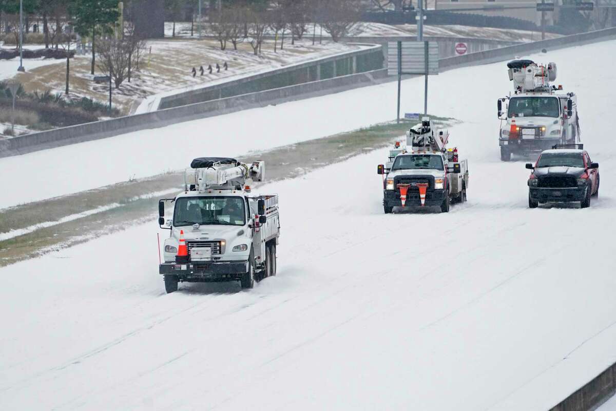 Entergy Power repair crews head north on Interstate 55 in north Jackson, Miss., Monday, Feb. 15, 2021, as light snow mixed with sleet, and rain continue to cover much of the state. The National Weather Service forecasts temperatures barely hovering at 20 degrees Fahrenheit, and likely slipping into the single digits by Tuesday morning. A winter storm warning continues throughout the state. (AP Photo/Rogelio V. Solis)