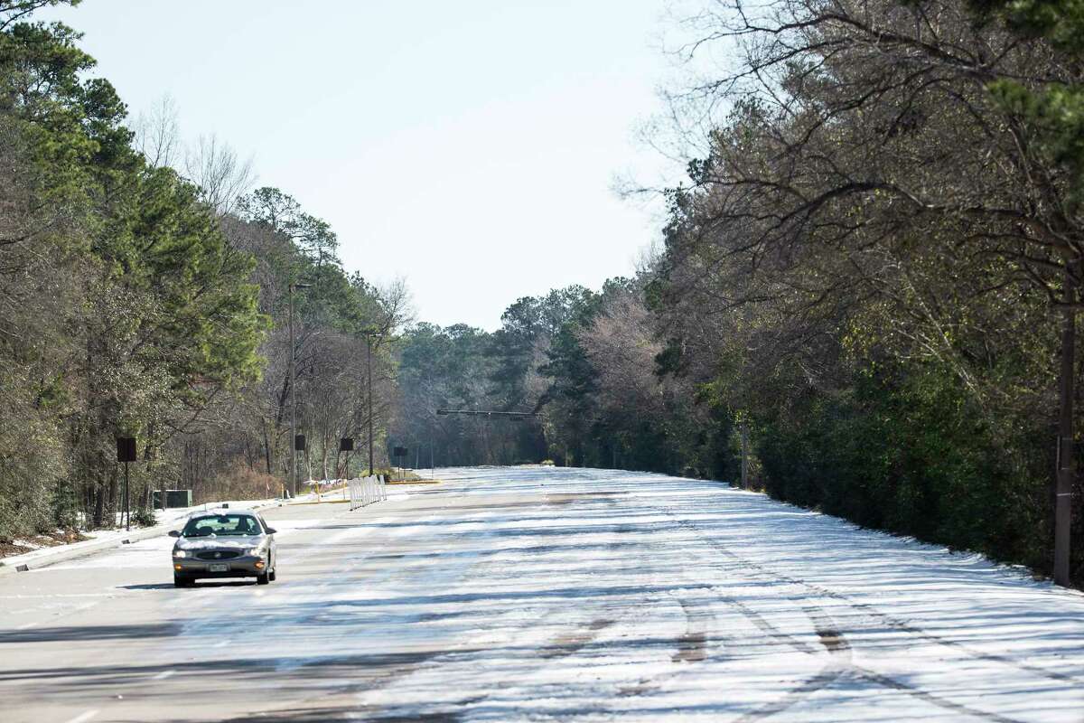 A single car drives along an empty Woodlands Parkway Tuesday, Feb. 16, 2021 in The Woodlands. Traffic continued to be light on the roadways as temperatures stayed below freezing Tuesday and roads remained icy.