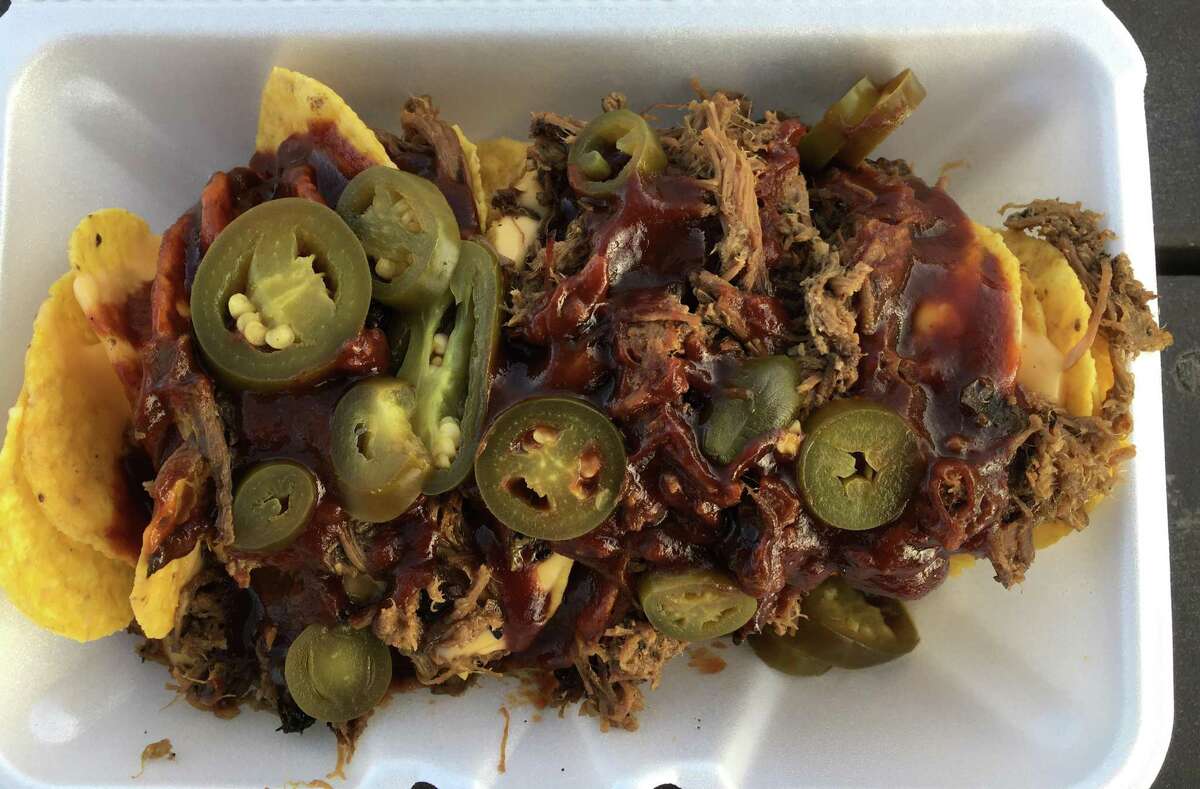 Cowchos are brisket nachos at The Purple Pig BBQ, topped with peppers, cheese and barbecue sauce.