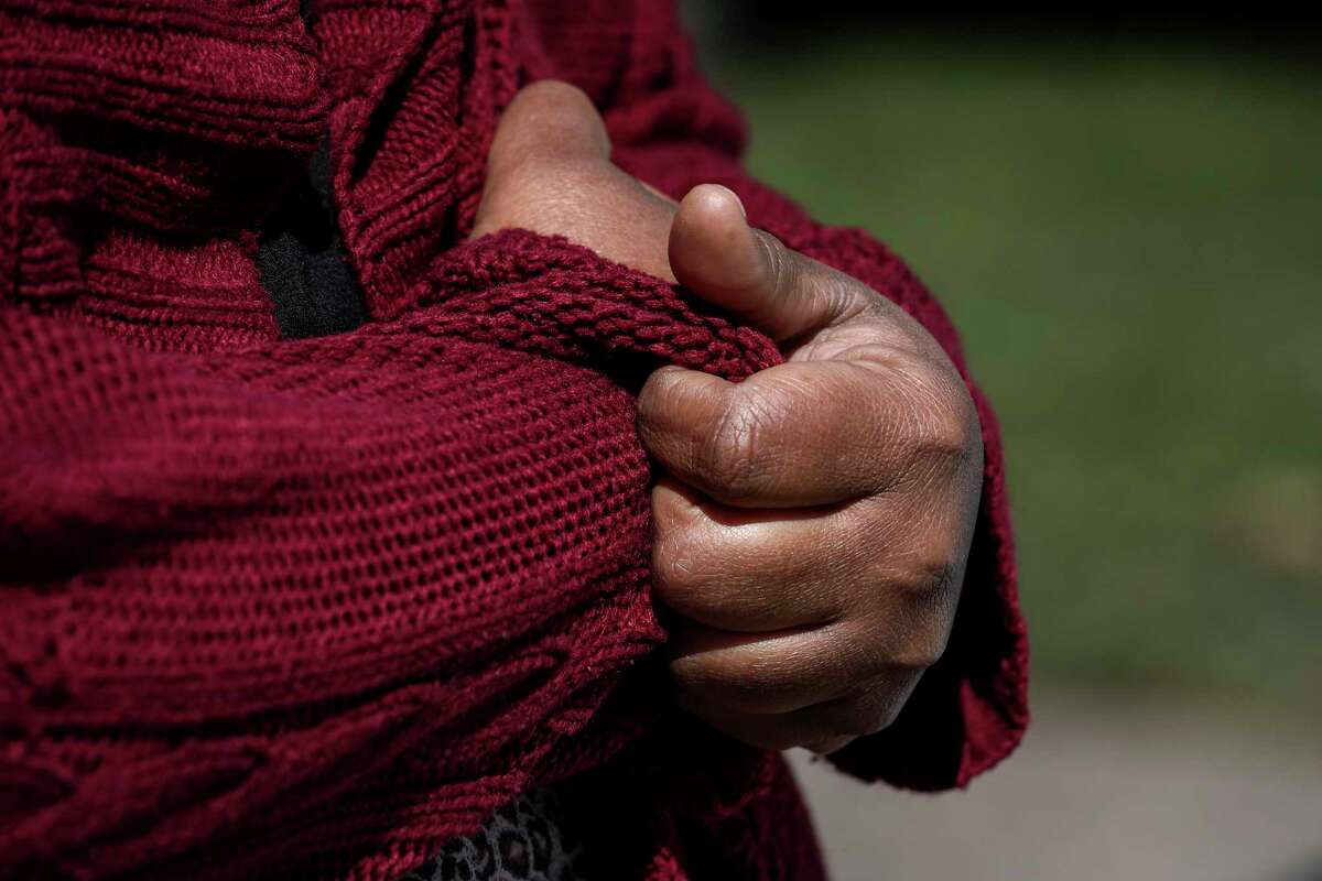 "I'm trying not to panic but it's hard," said Alicia Carr as she wraps her sweater around her body Tuesday, Feb. 16, 2021, at Cuney Homes in Houston.