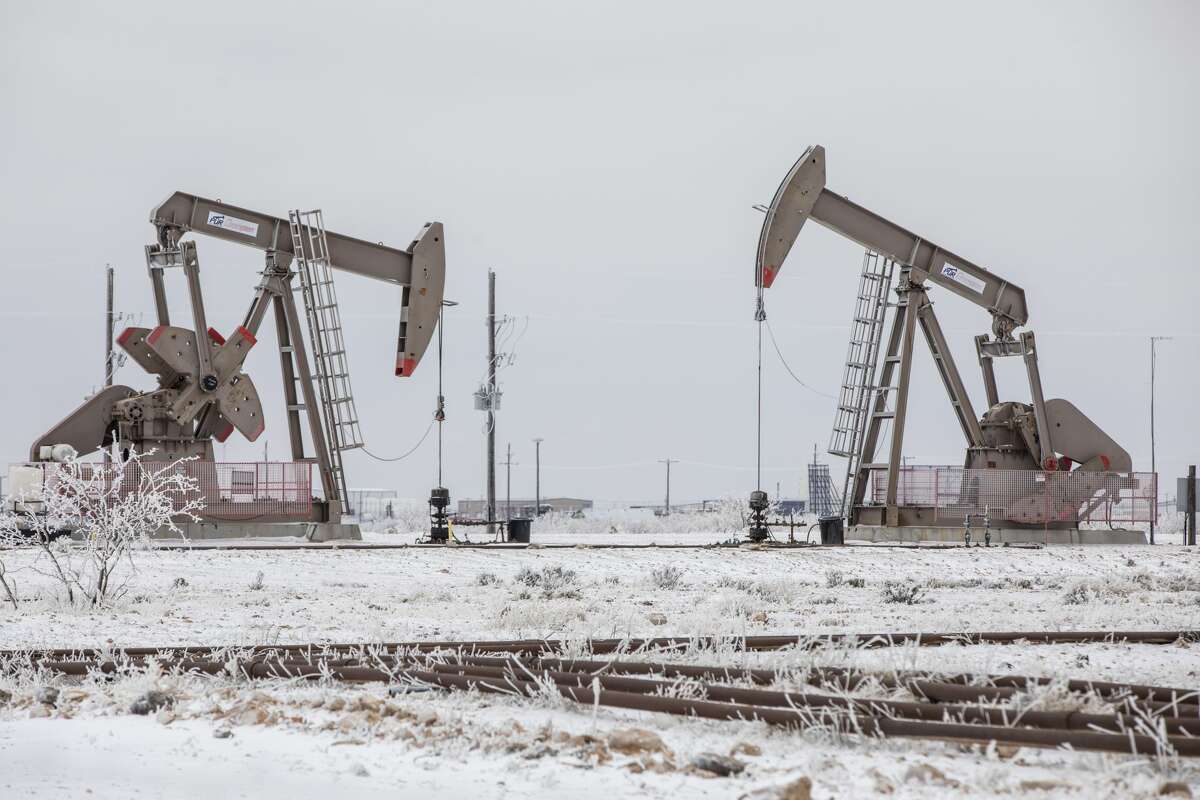 Pumpjacks operate in the snow in the Permian Basin in Midland, Texas in Feb. 2021.