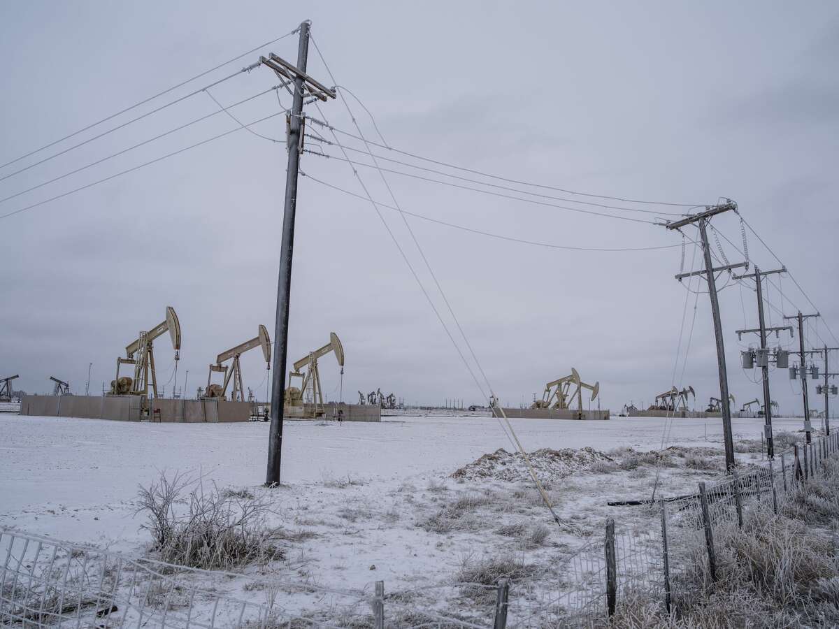 FILE PHOTO: Pump jacks operate in the Permian Basin in Midland, Texas, U.S, on Saturday, Feb. 13, 2021. 