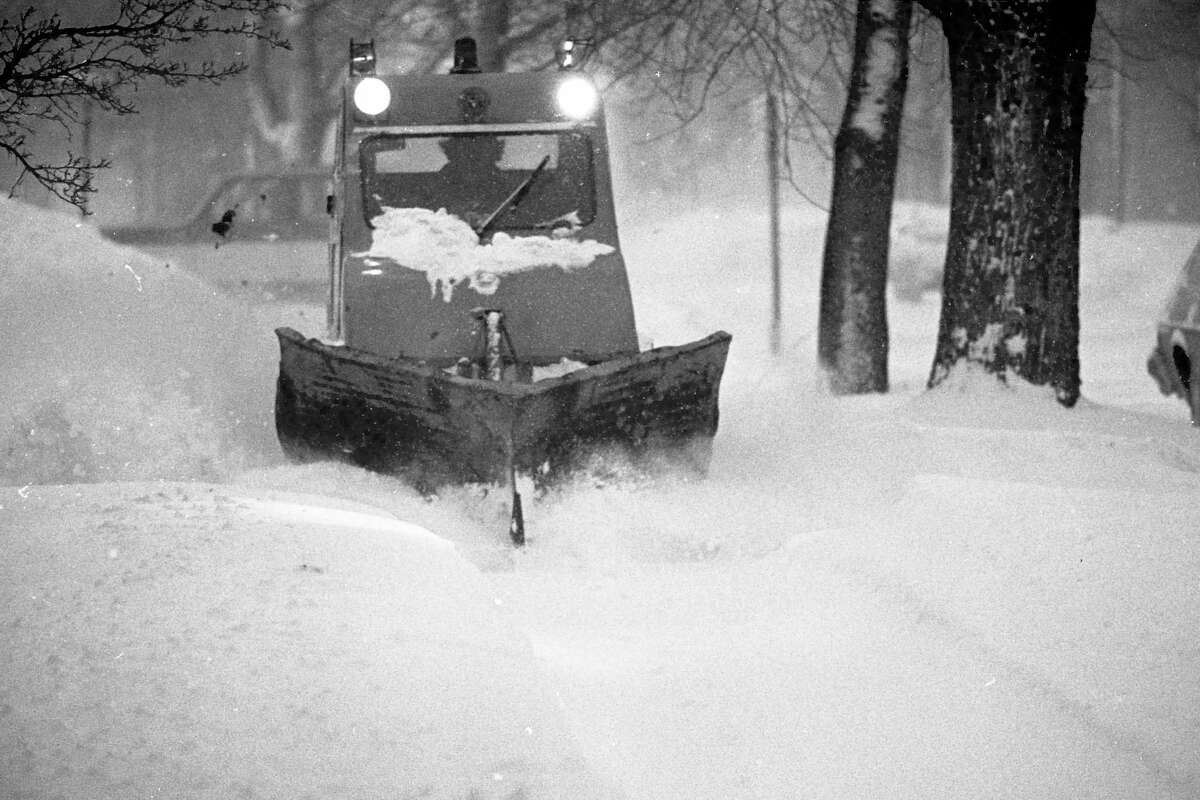 Tracked vehicles began plowing sidewalks in Manistee in 1981. Public Works Director Jeff Mikula said the city's sidewalk ordinance making residents responsible for maintenance has been in place for decades. (Manistee County Historical Museum photo)