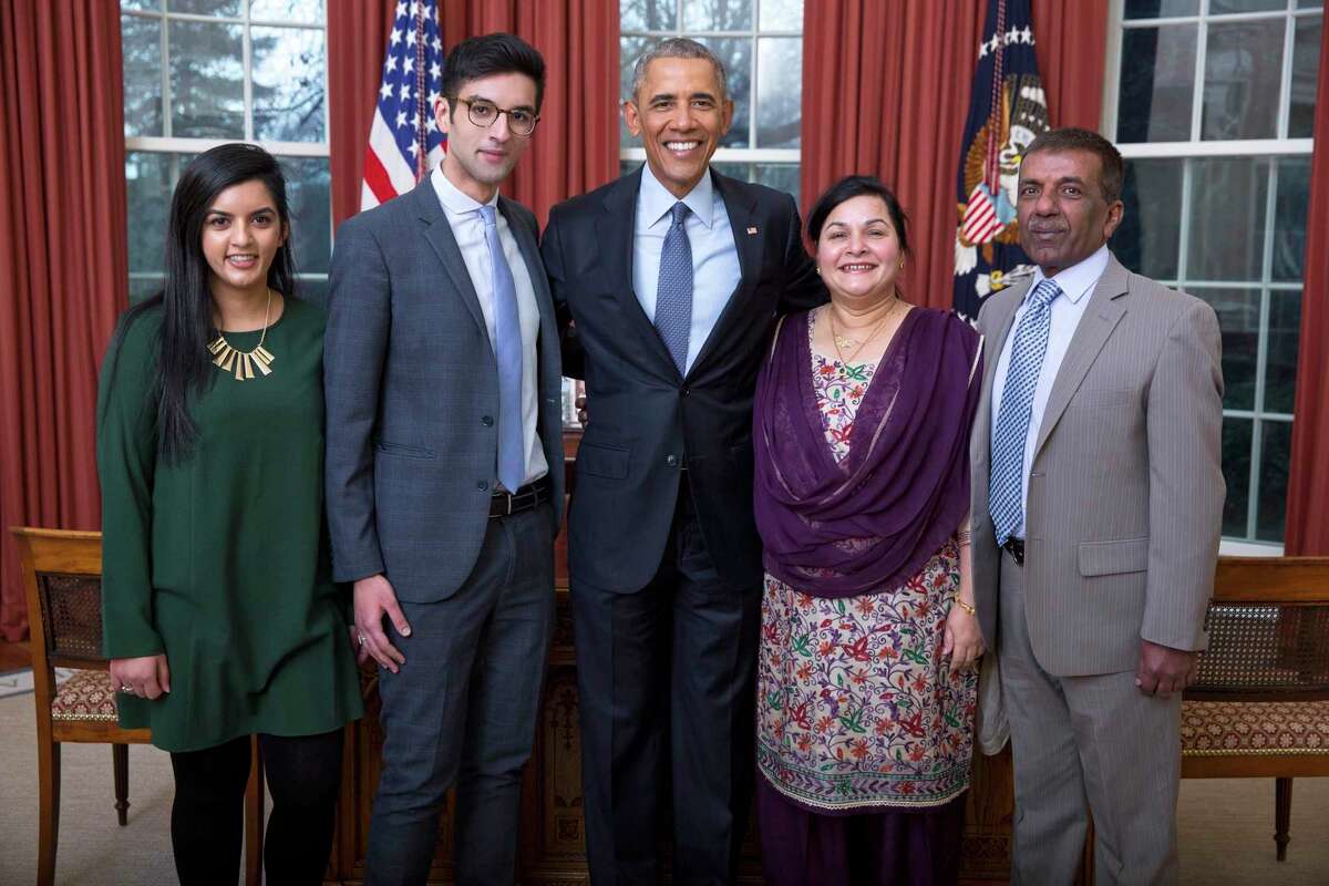 President Barack Obama poses with Abdullah Hasan and his family members in the Oval Office on Jan. 6, 2017.