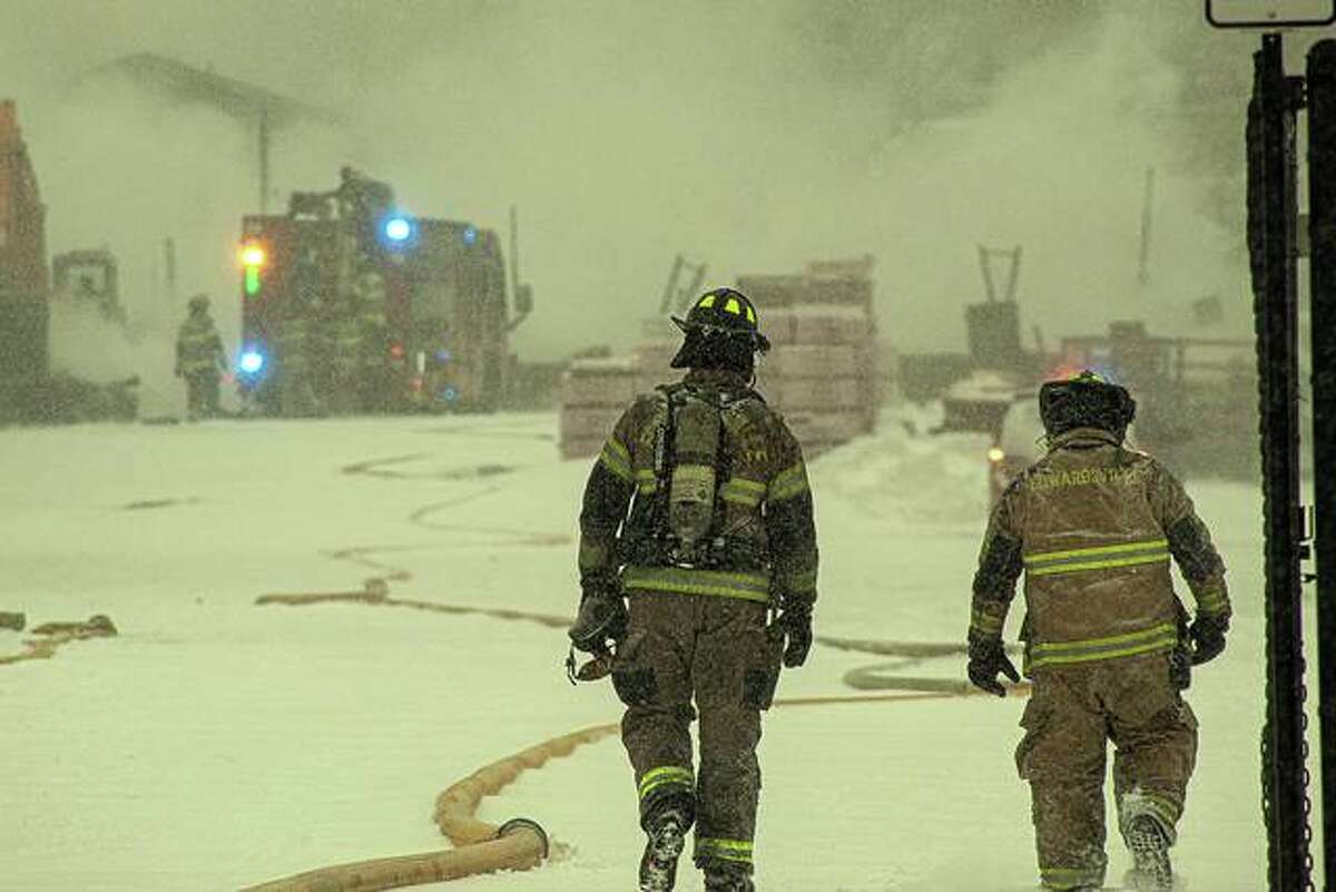 Edwardsville fire crews battled a fire plus frigid temperatures and snow Monday as they worked for hours to extinguish a blaze at R. P. Lumber.
