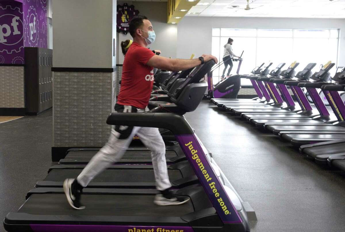 Oscar Vegas, of Danbury, uses a treadmill at Planet Fitness on Thursday morning, February 11, 2021, in Danbury, Conn