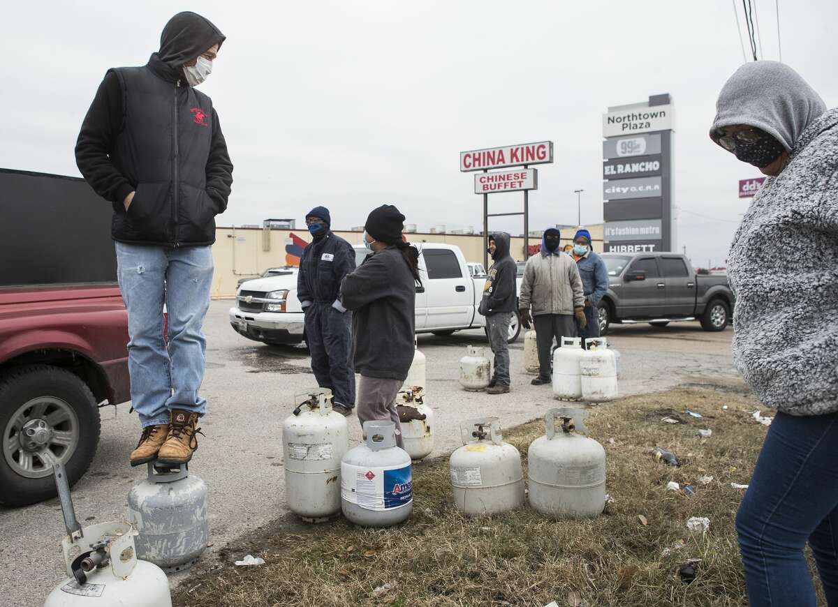 People line up to fill their empty propane tanks at a business on the North Freeway Tuesday, Feb. 16, 2021 in Houston. Temperatures stayed below freezing Tuesday, with many still without power.