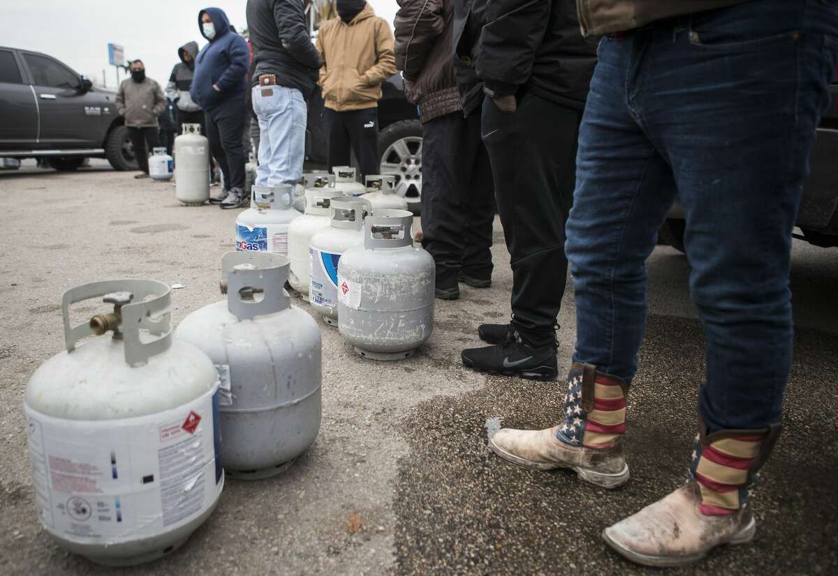 People line up to fill their empty propane tanks at a business on the North Freeway Tuesday, Feb. 16, 2021 in Houston. Temperatures stayed below freezing Tuesday, with many still without power.