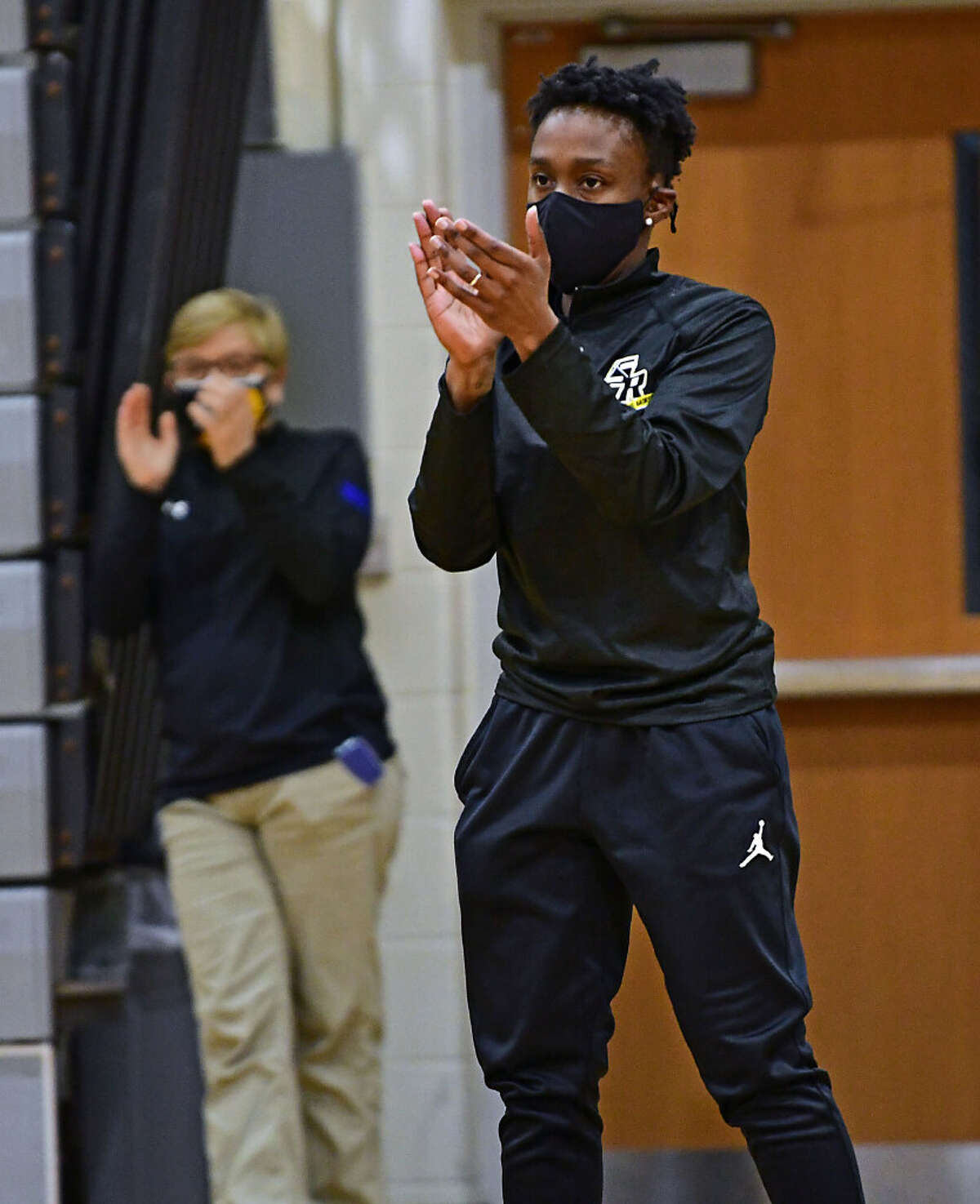 Saint Rose women's basketball head coach Whitney Edwards watches her players during a game against Mercyhurst in her first season with the Golden Knights on Tuesday, Feb. 16, 2021 in Albany, N.Y. Former women's basketball head coach Karen Haag watches the game at left. (Lori Van Buren/Times Union)