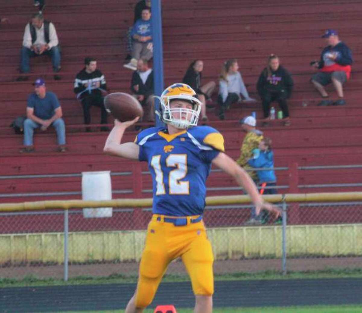 In this file photo, Evart senior Danny Witbeck is pictured throwing a football during a warmup prior to a Wildcats game. During a basketball practice in late January, Witbeck suffered cardiac arrest, but is now recovering thanks to the quick reactions from his coaches and teammates. During a recent school board meeting, the board agreed to purchase additional AEDs and offer CPR training. (Herald Review file photo)